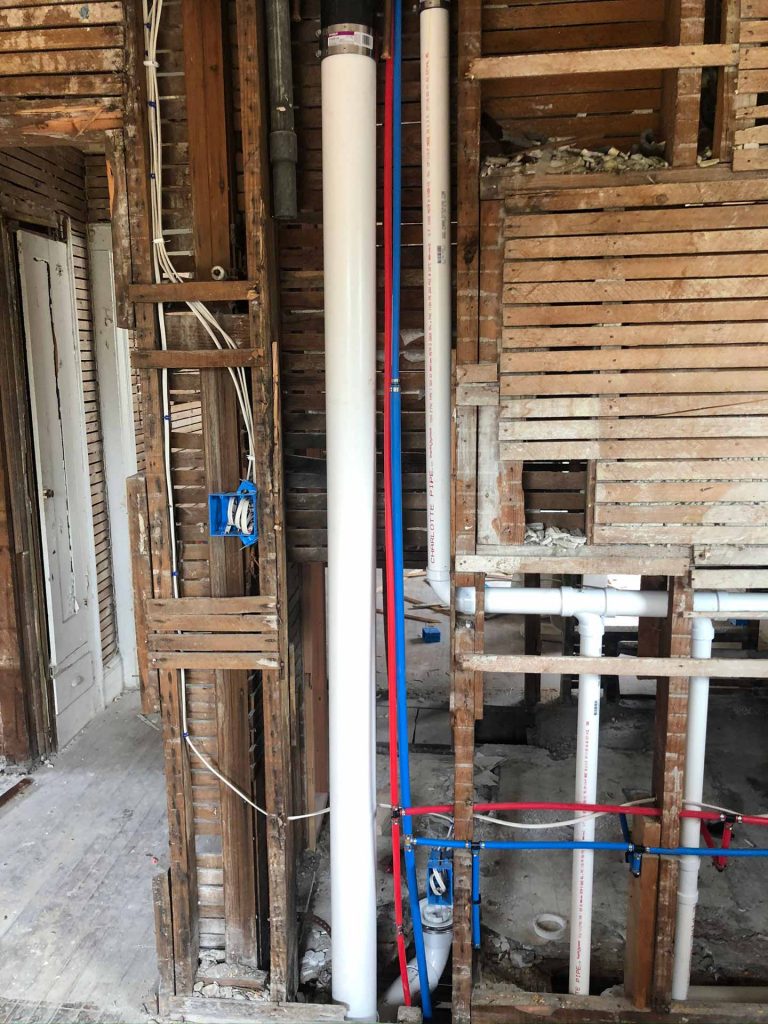 Exposed plumbing inside of wall