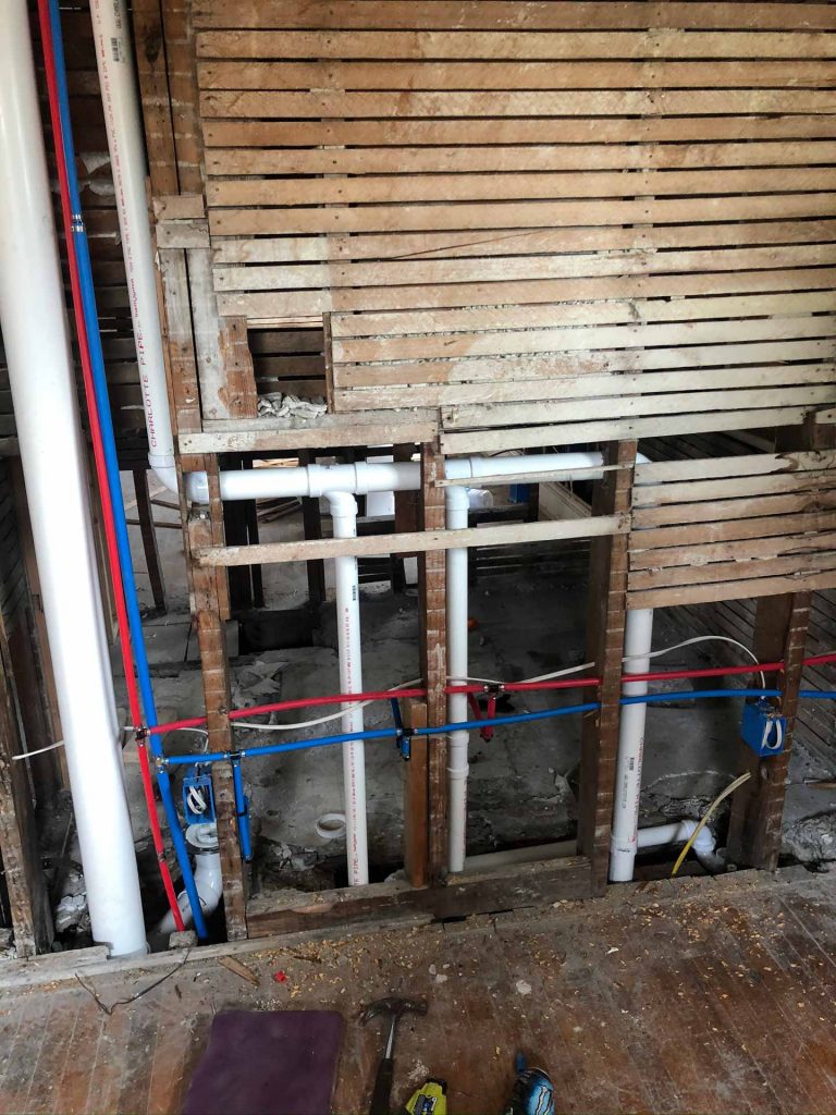 Exposed plumbing inside of wall