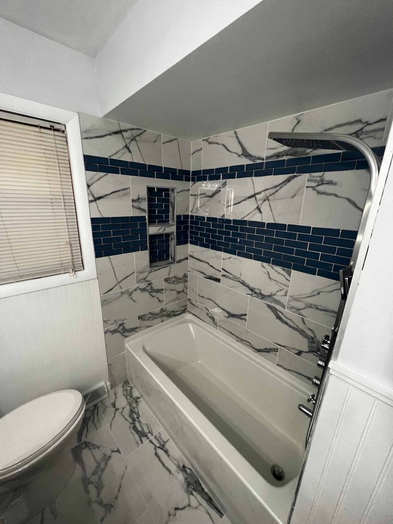 Shower with decorative tiling on walls