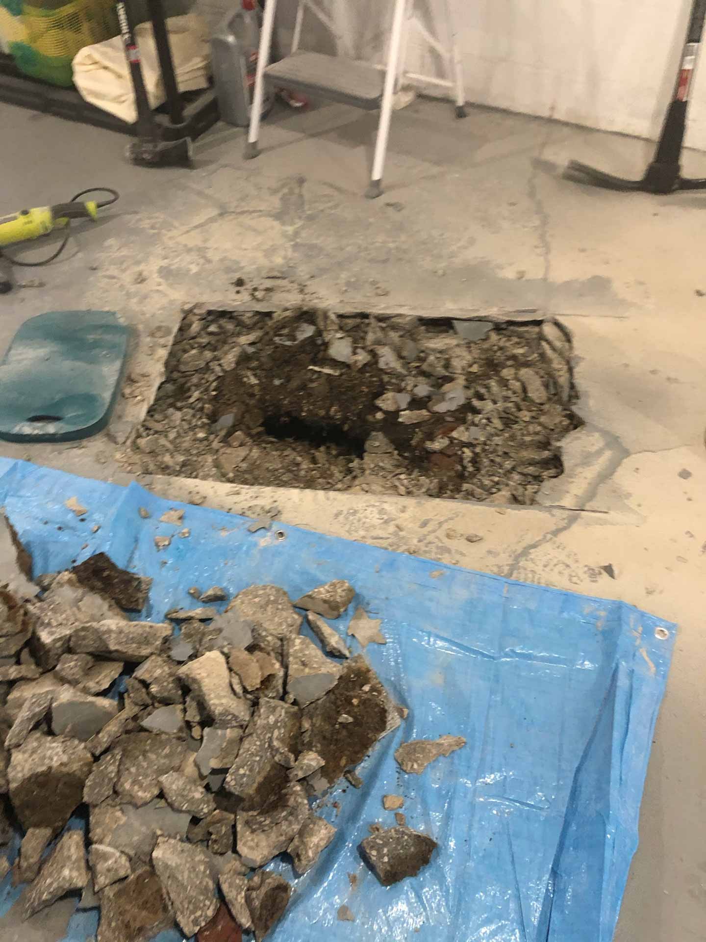 Concrete basement floor with hole
