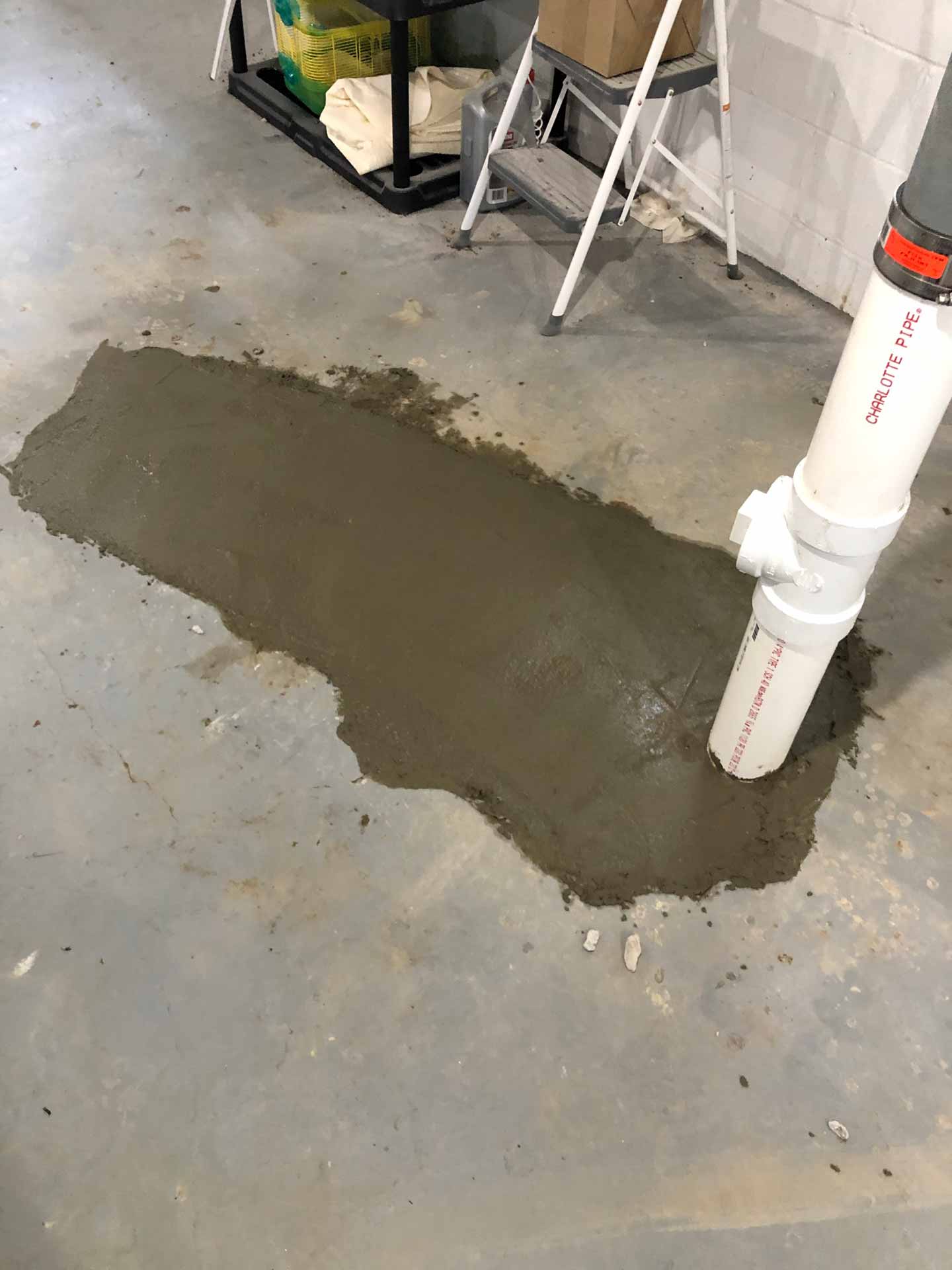 Hole in basement floor patched up with fresh concrete