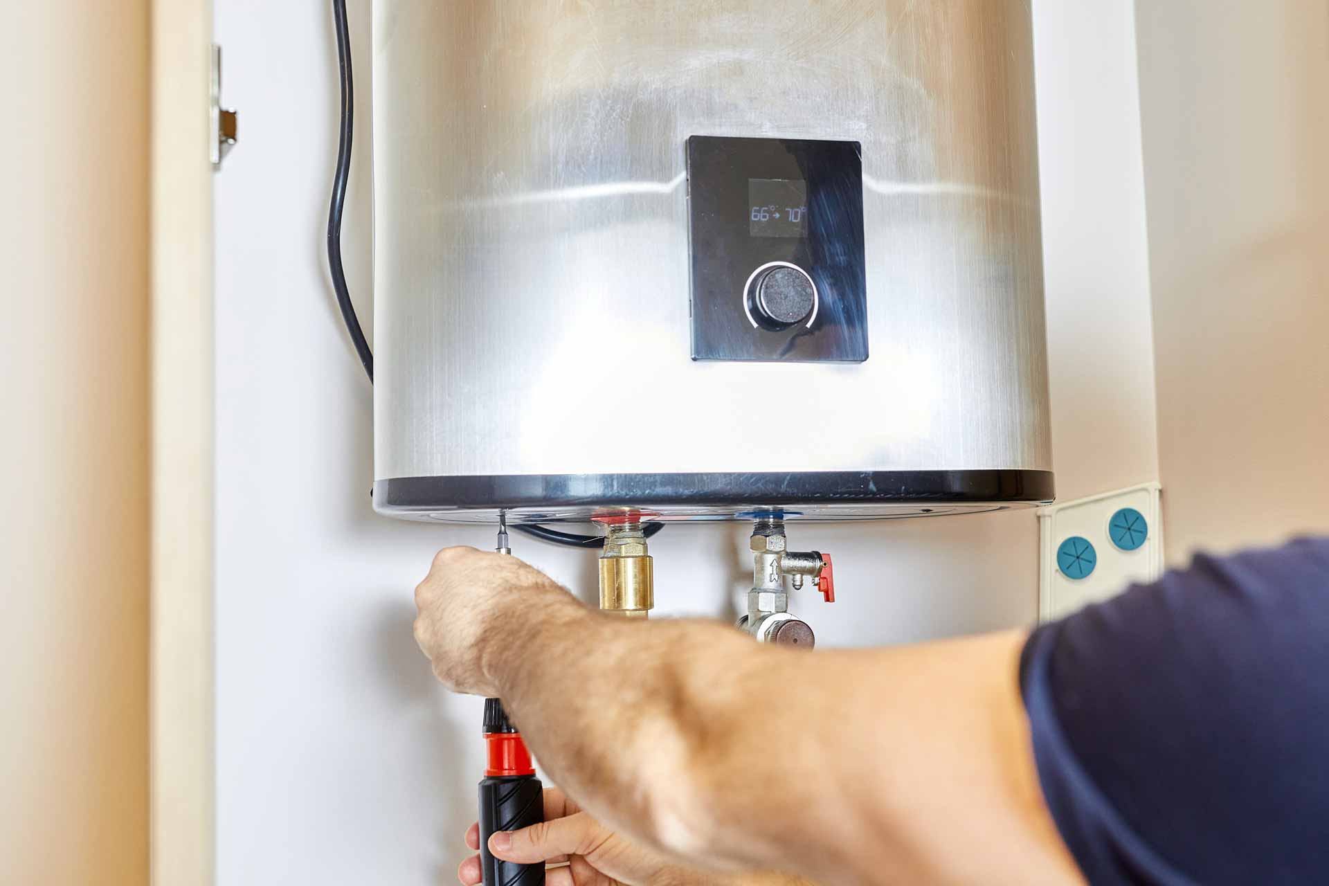 Technician repairs a tankless hot water heater