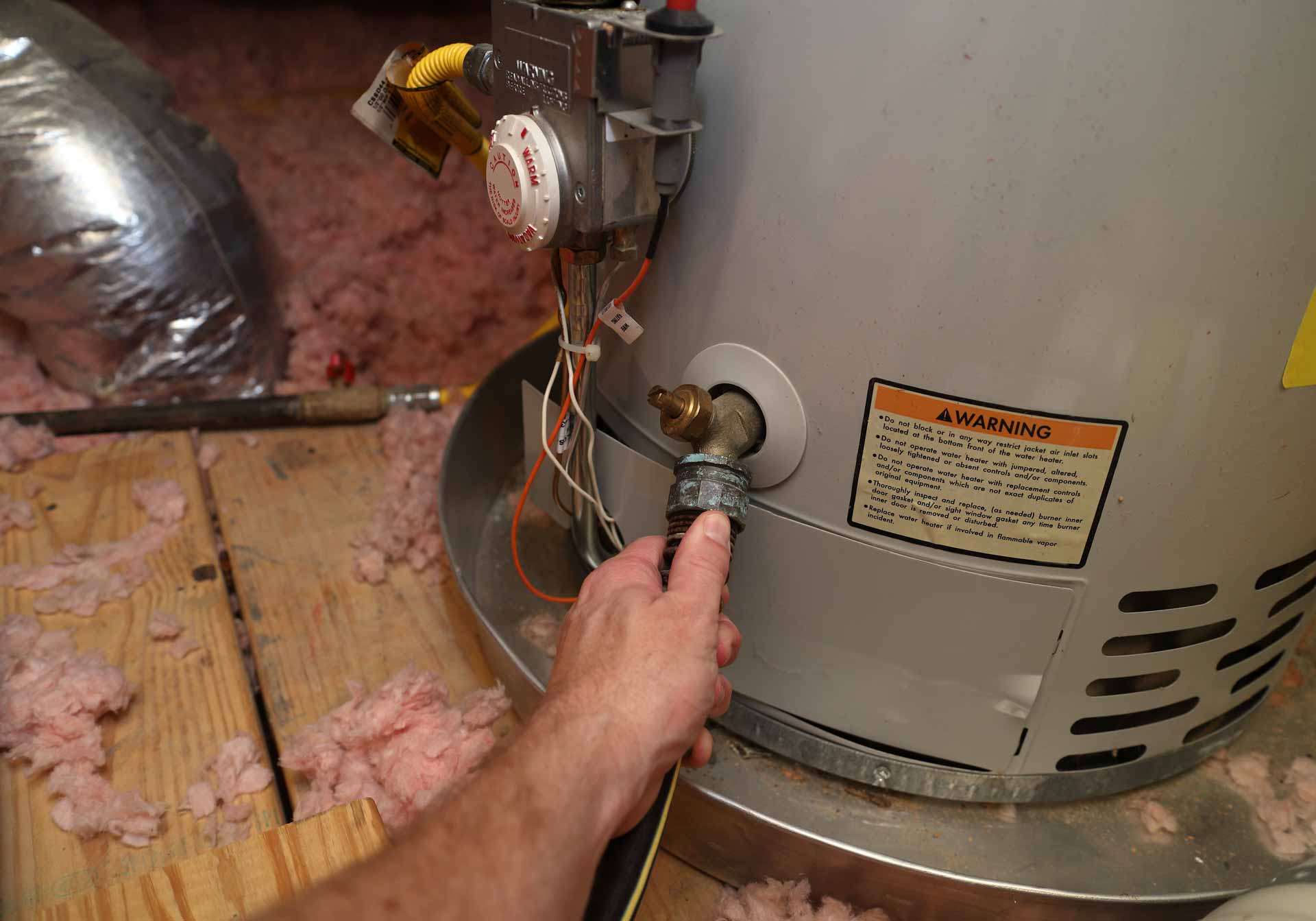 Attaching a hose to a water heater to drain it